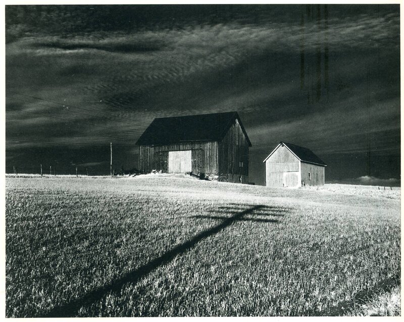 Barns under stormy sky