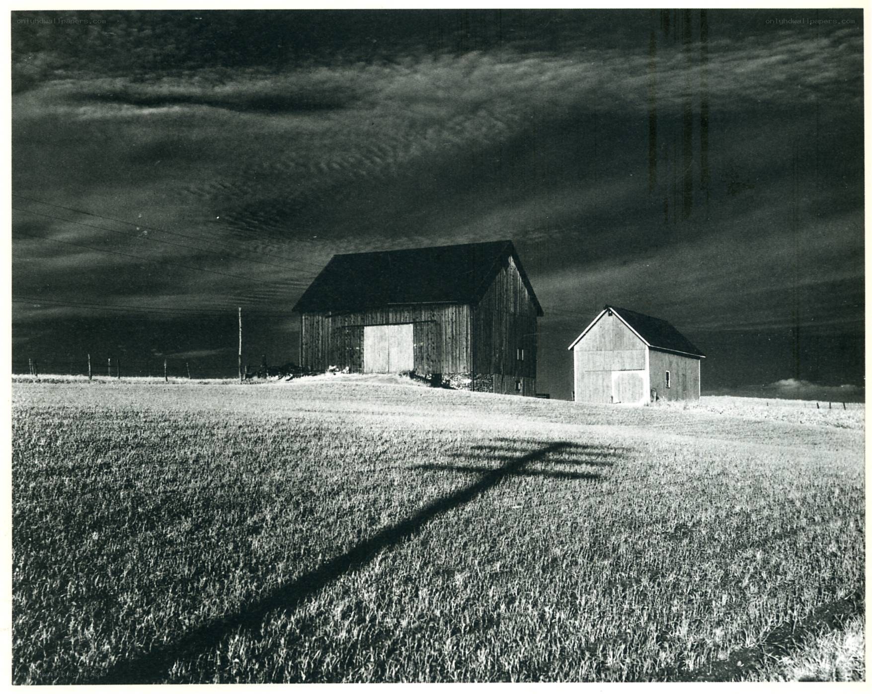 Barns under stormy sky