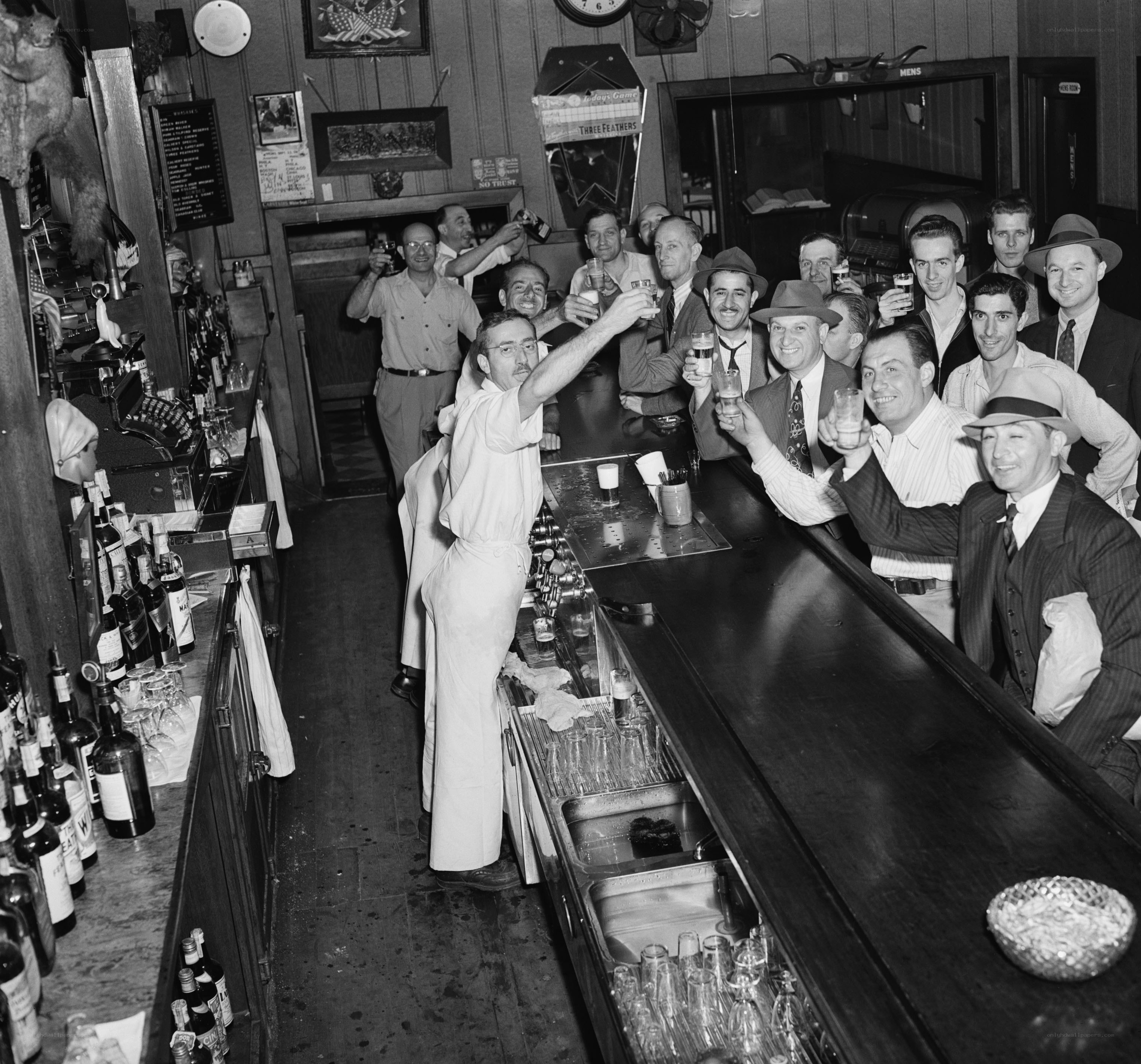 Bartender toasts patrons at bar