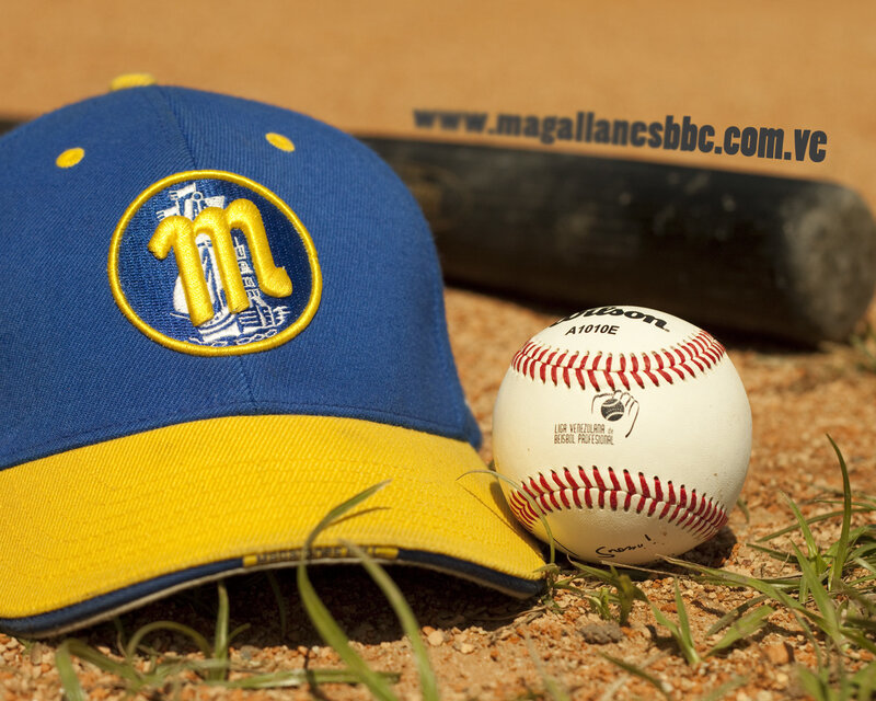 baseball cap and ball on dirt