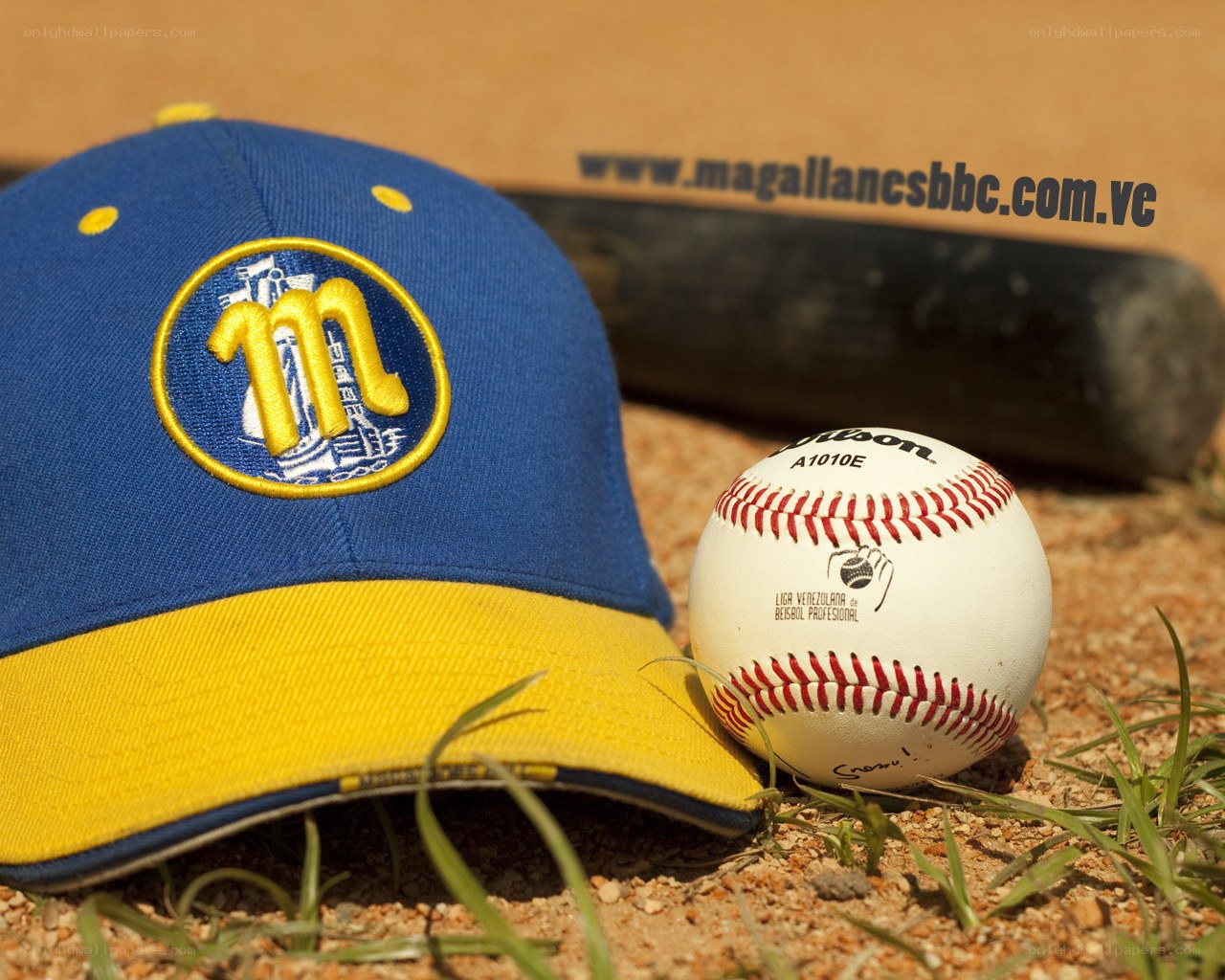 baseball cap and ball on dirt