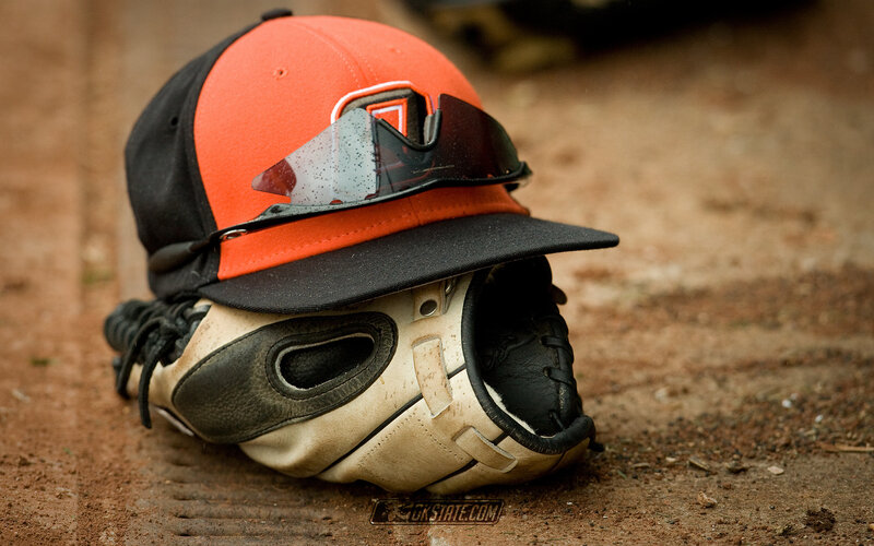 Baseball gear on dirt field