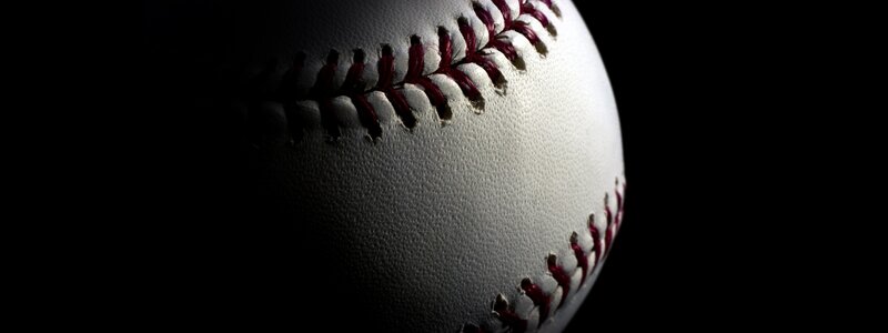 Baseball on Black Background — White