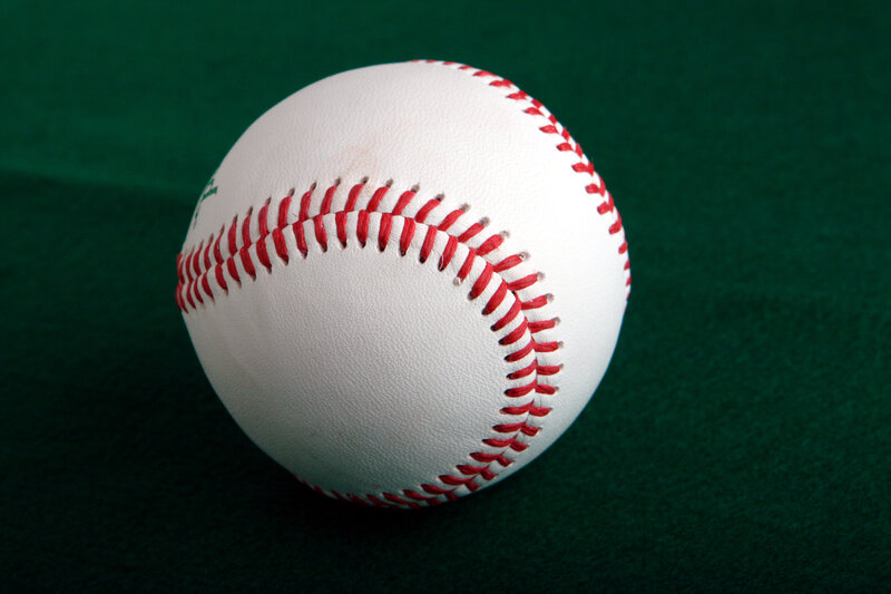 Baseball on green surface