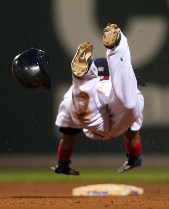 Baseball player falling after collision