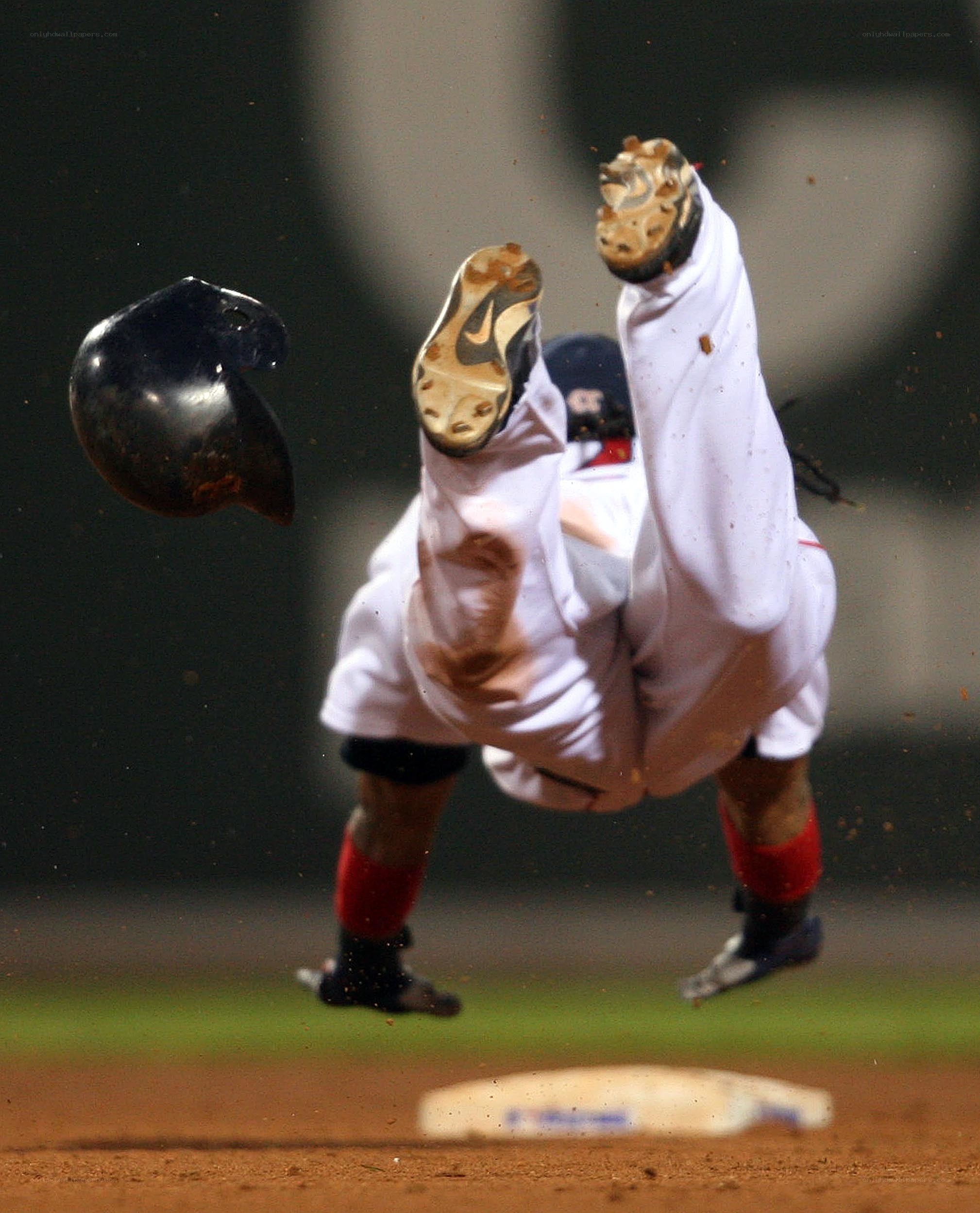Baseball player falling after collision