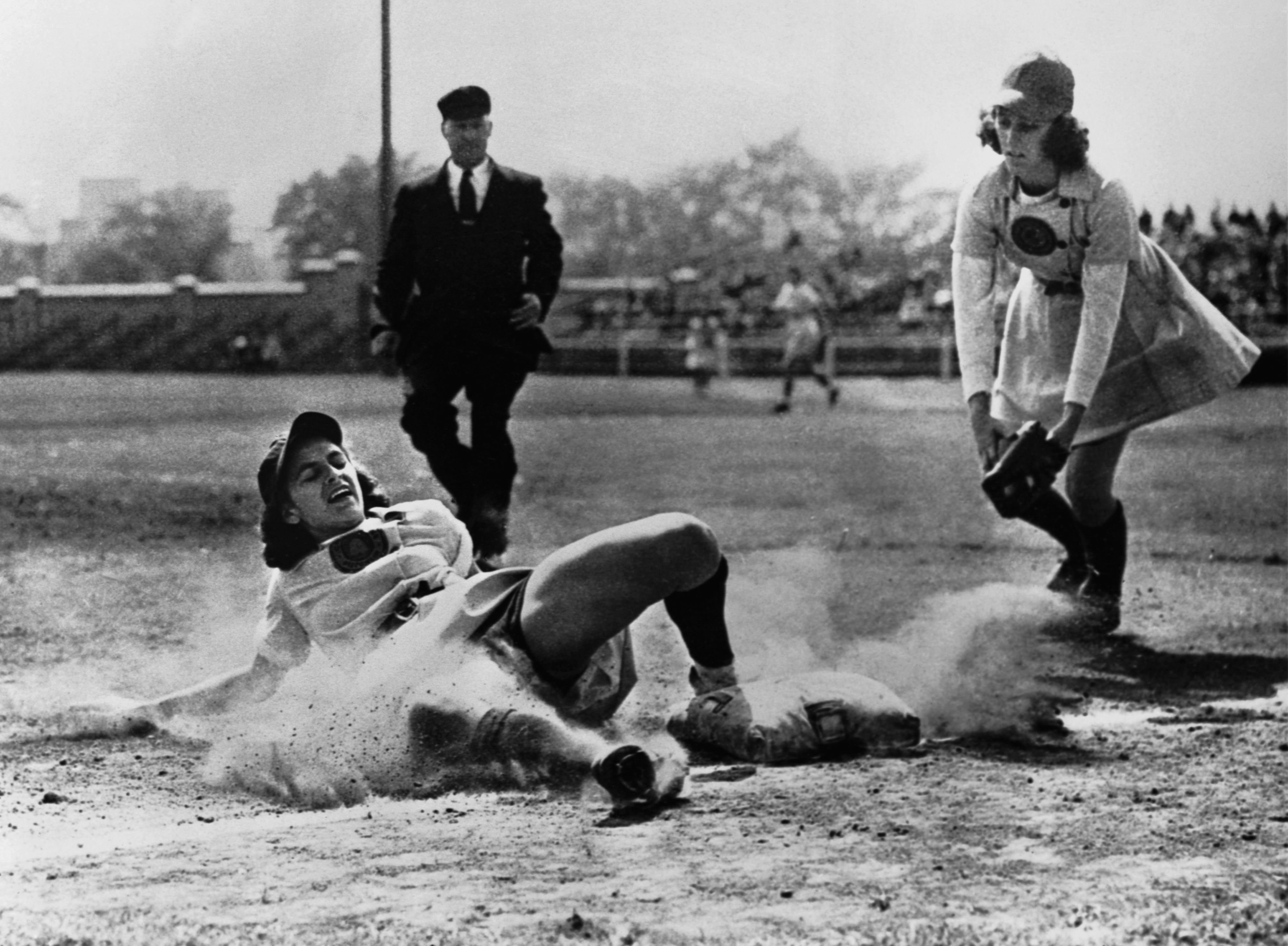 Baseball player sliding into base