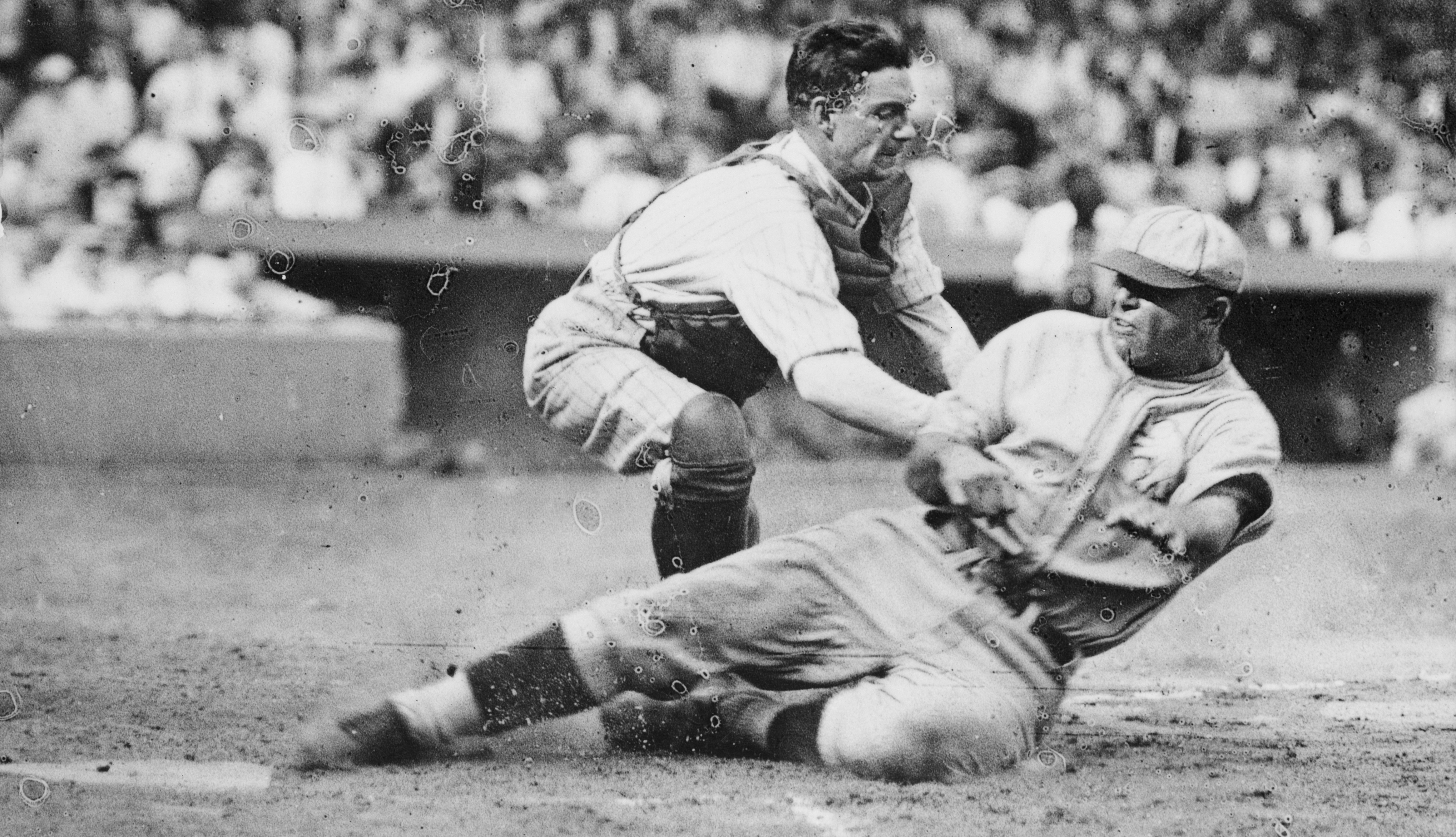 baseball player sliding into home