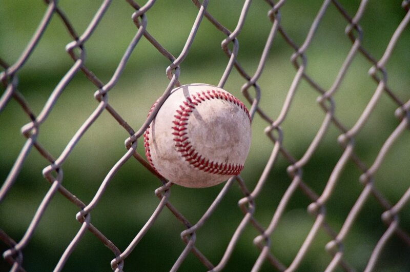 Baseball stuck in chain-link fence