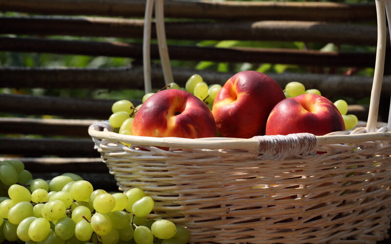Basket of Peaches and Grapes