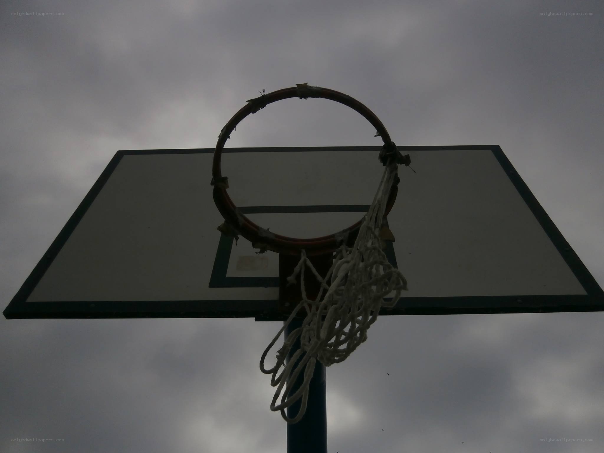basketball hoop against cloudy sky