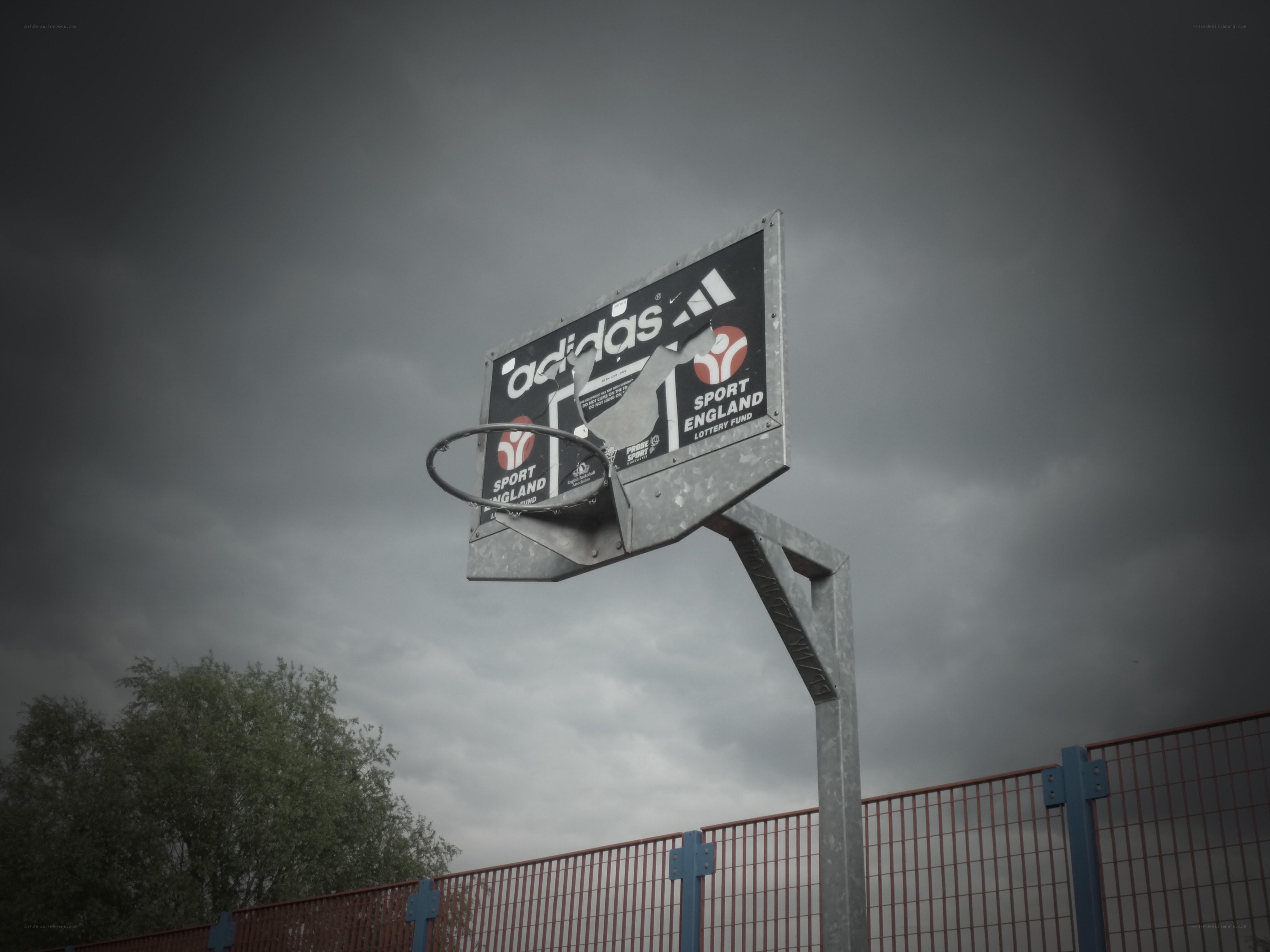 basketball hoop under stormy sky