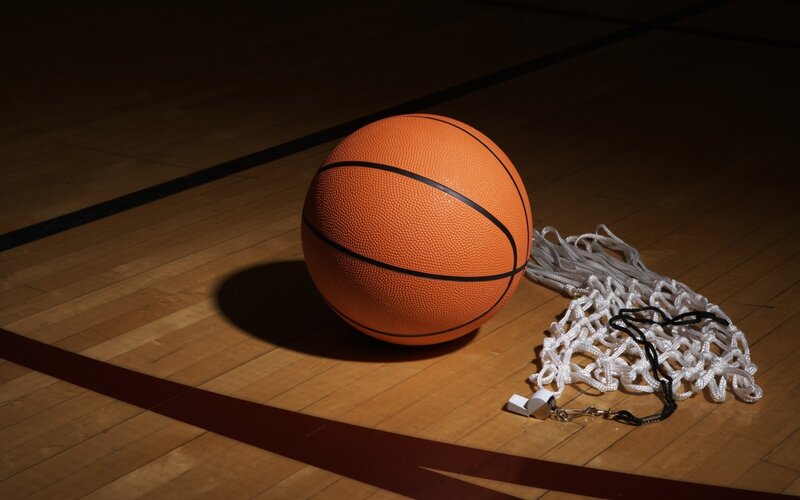 Basketball on court with net