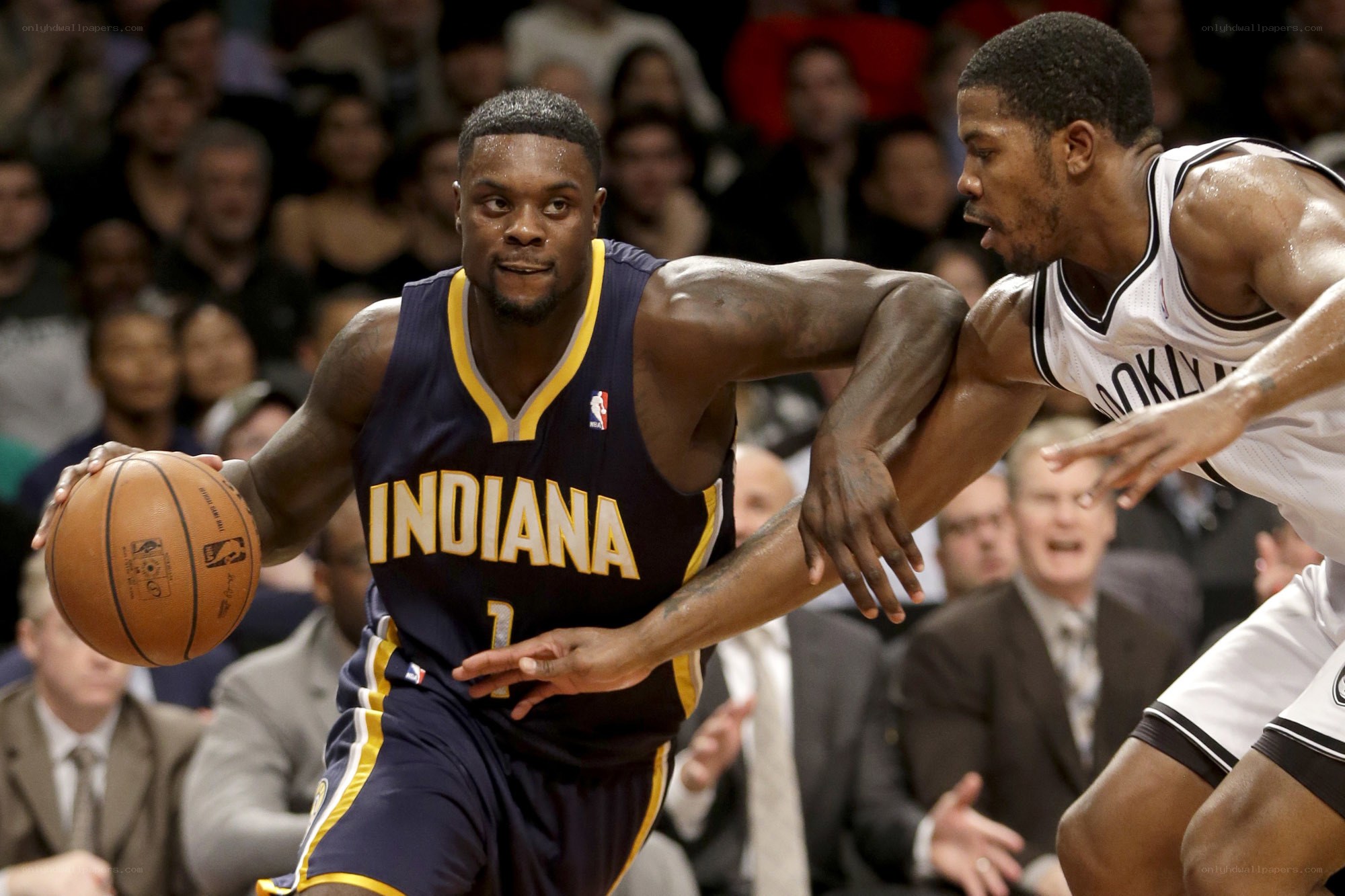 Basketball player dribbling under defense