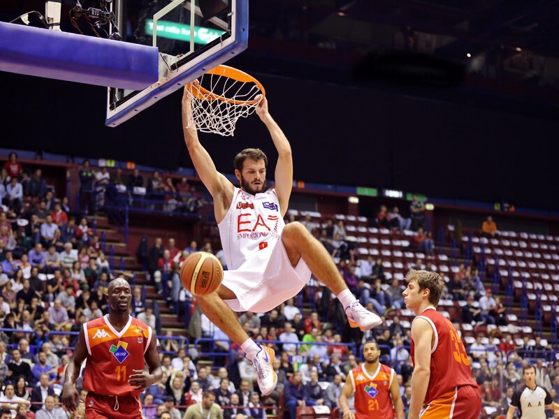 Basketball player dunks ball