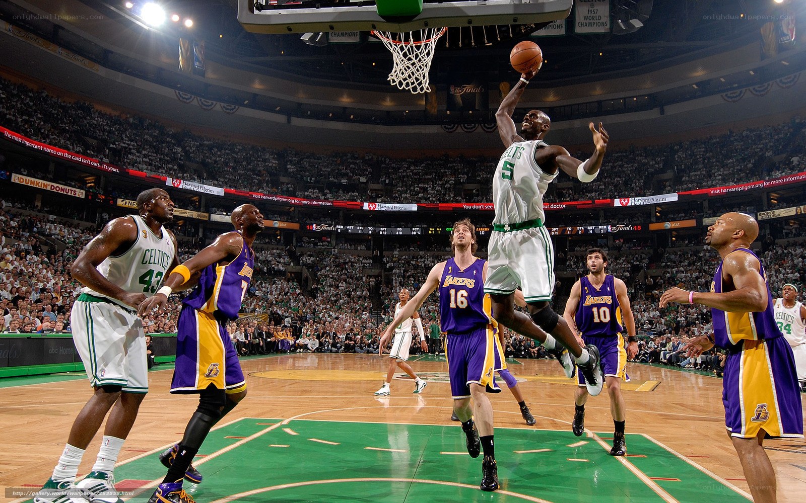 Basketball player dunks ball