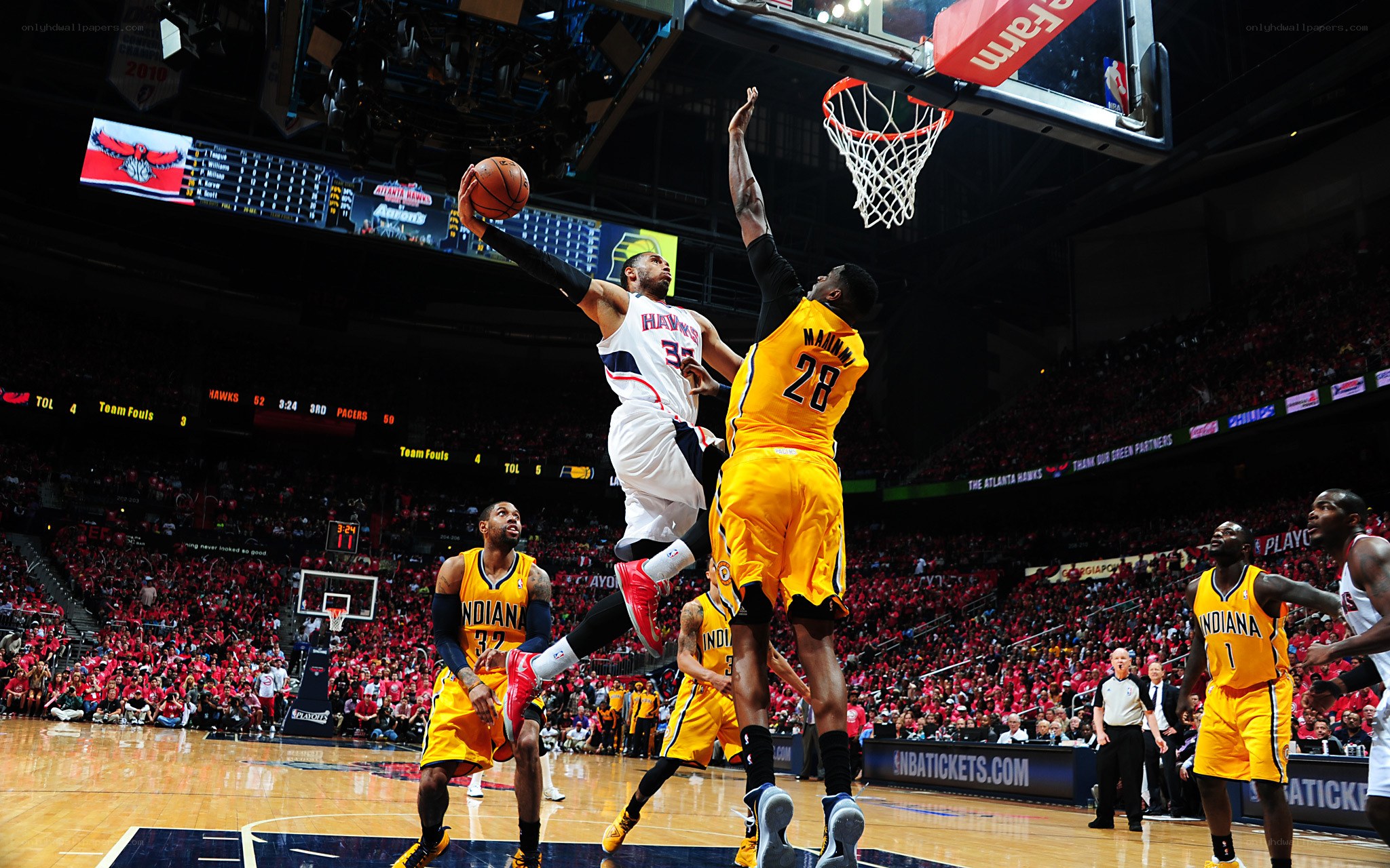 Basketball player dunks during game