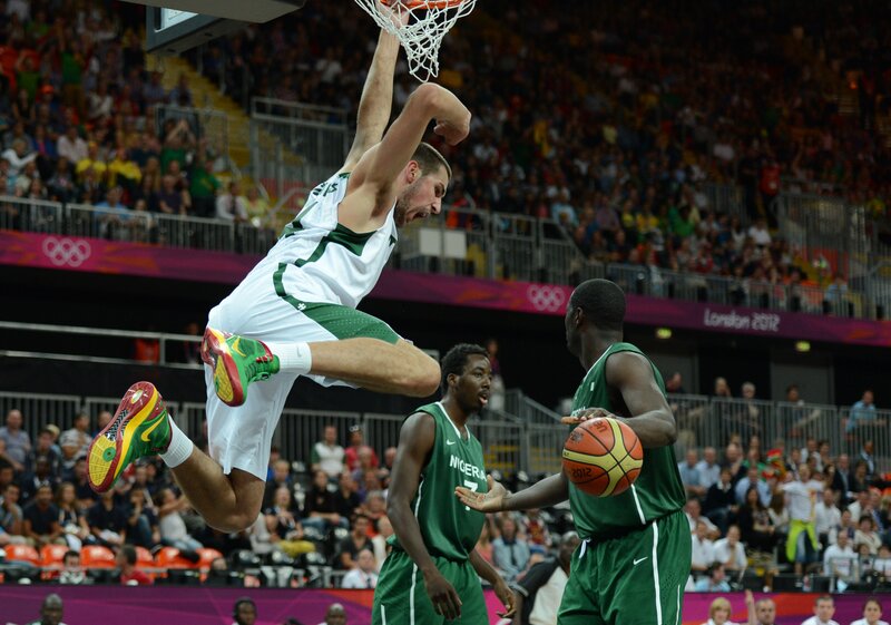 Basketball player dunks during game