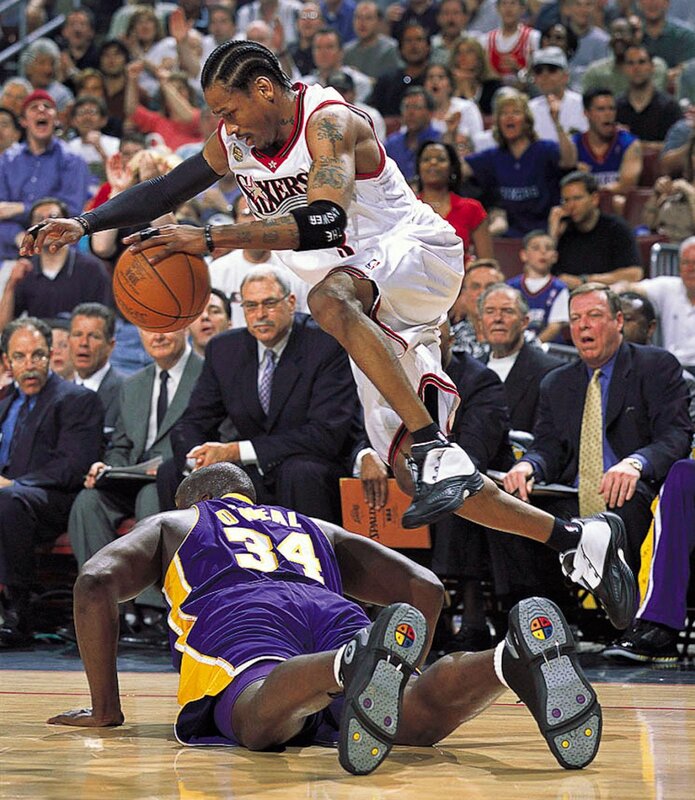 Basketball player jumping over opponent