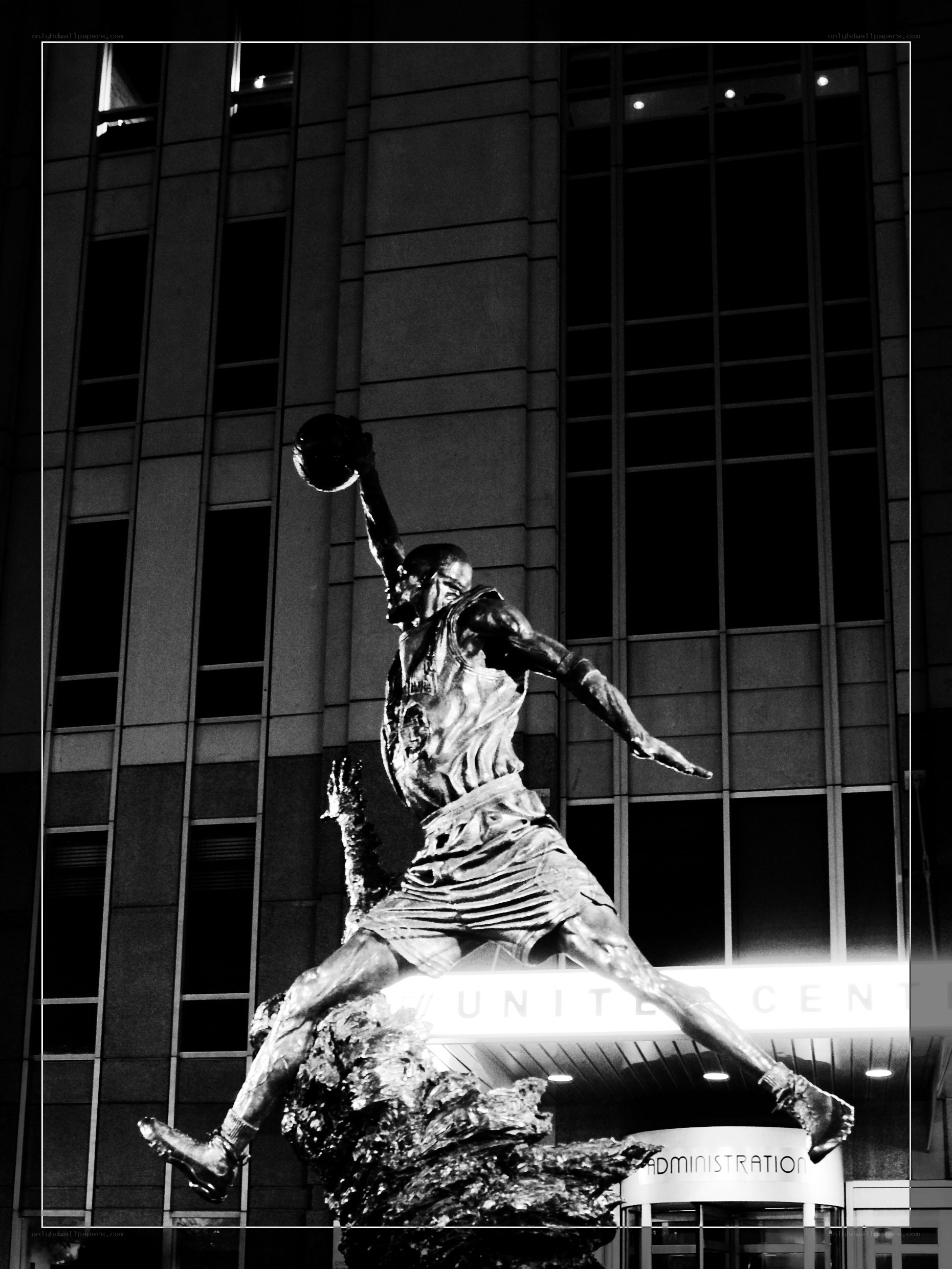 Basketball player statue at night