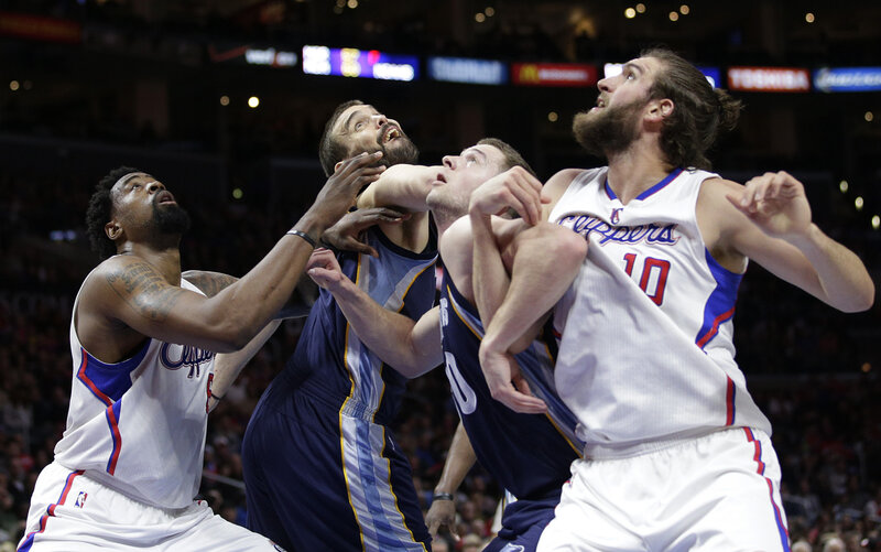 Basketball players fighting for rebound