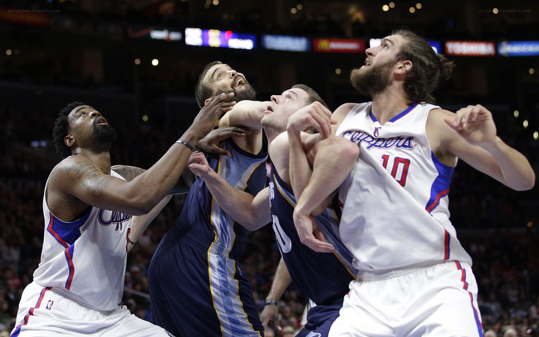 Basketball players fighting for rebound