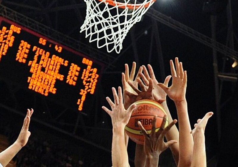 Basketball Players Reaching for Ball