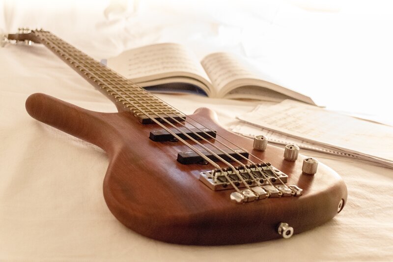 Bass guitar on a bed