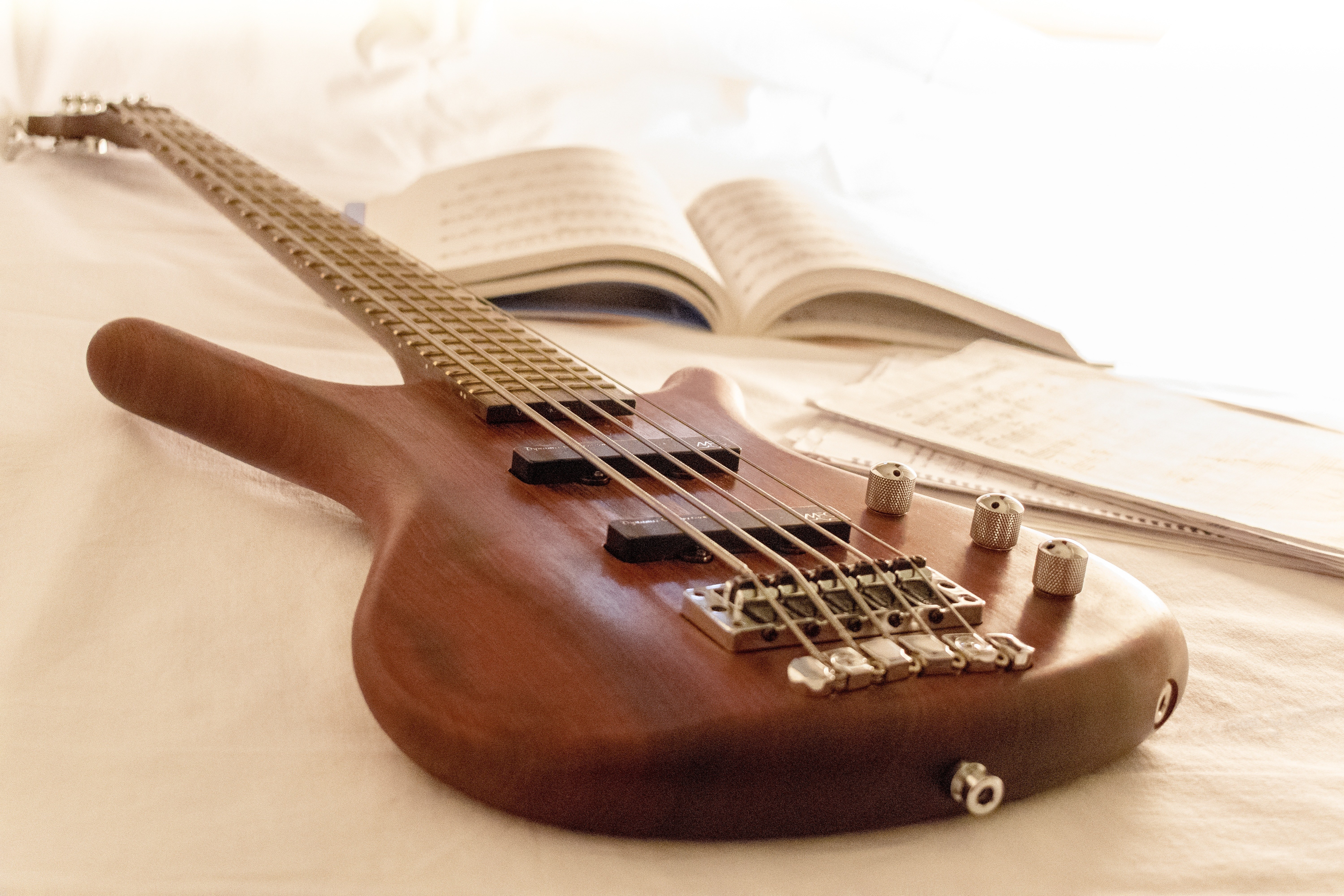 Bass guitar on a bed