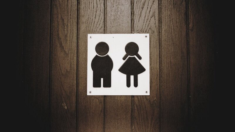 bathroom sign on wood wall