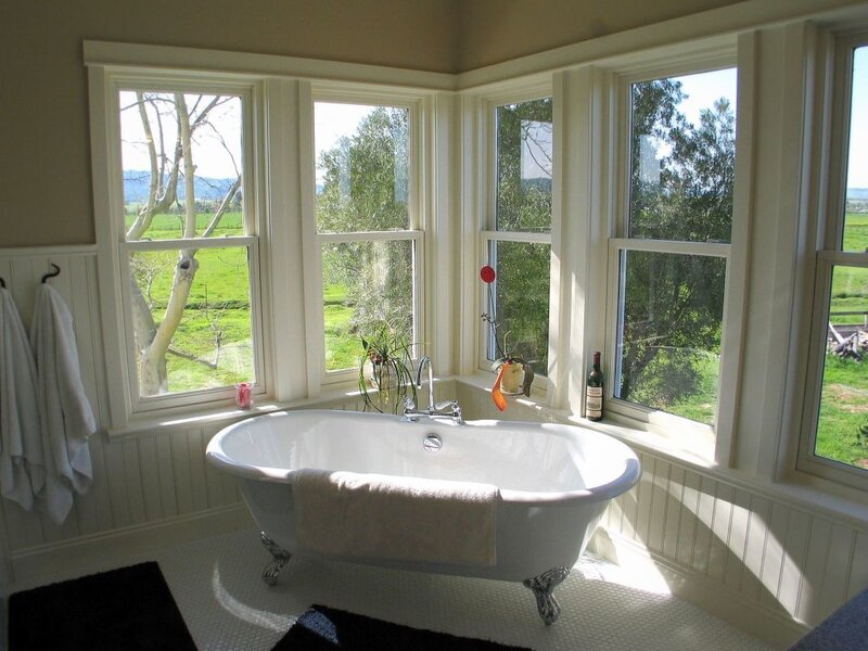 Bathroom with clawfoot tub and window view