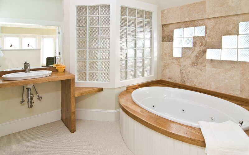 Bathroom with wooden vanity and tub