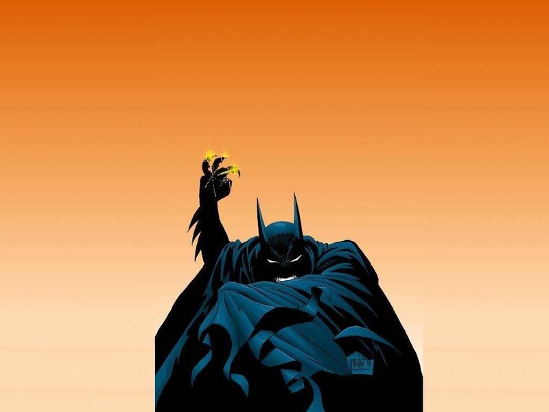 Batman holding a gadget