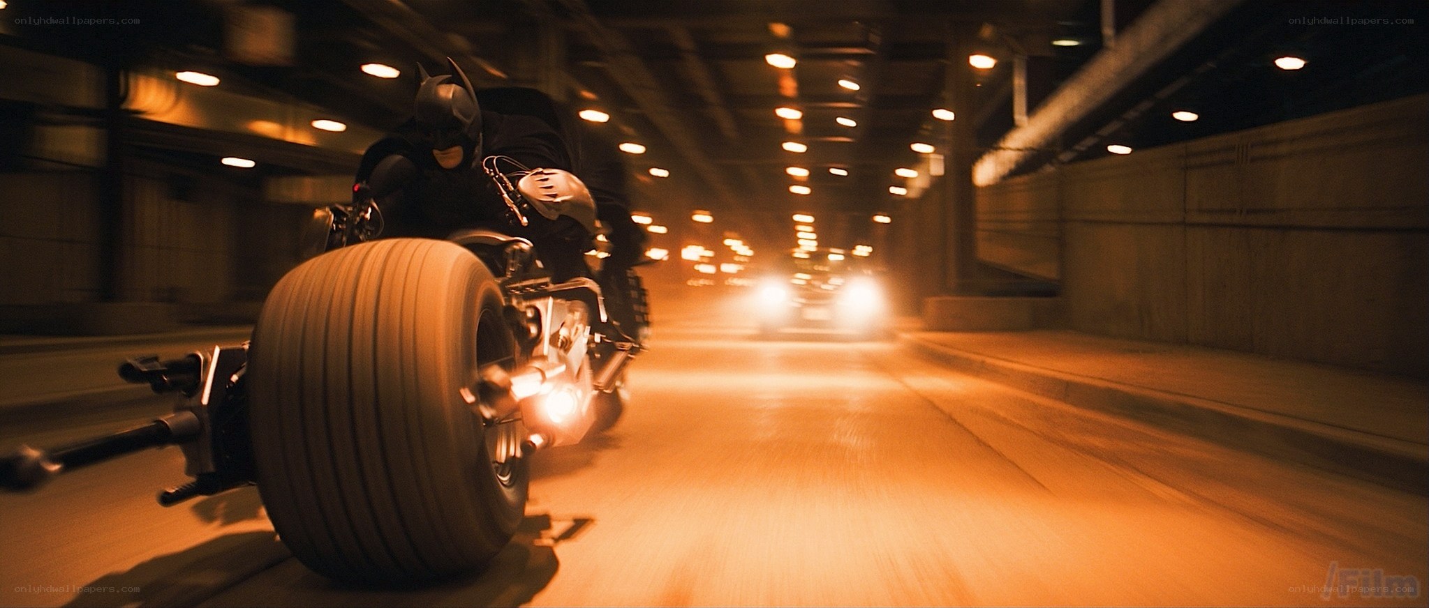 Batman on a motorcycle in tunnel