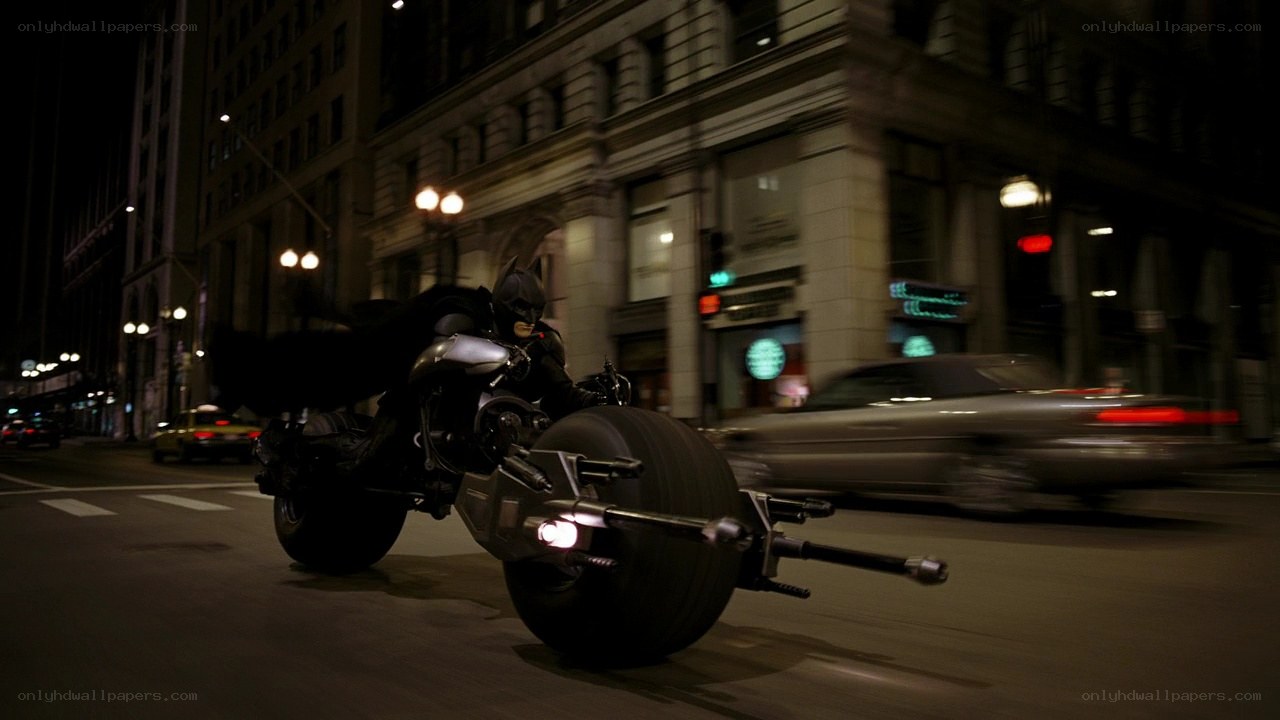 Batman on Batpod at night