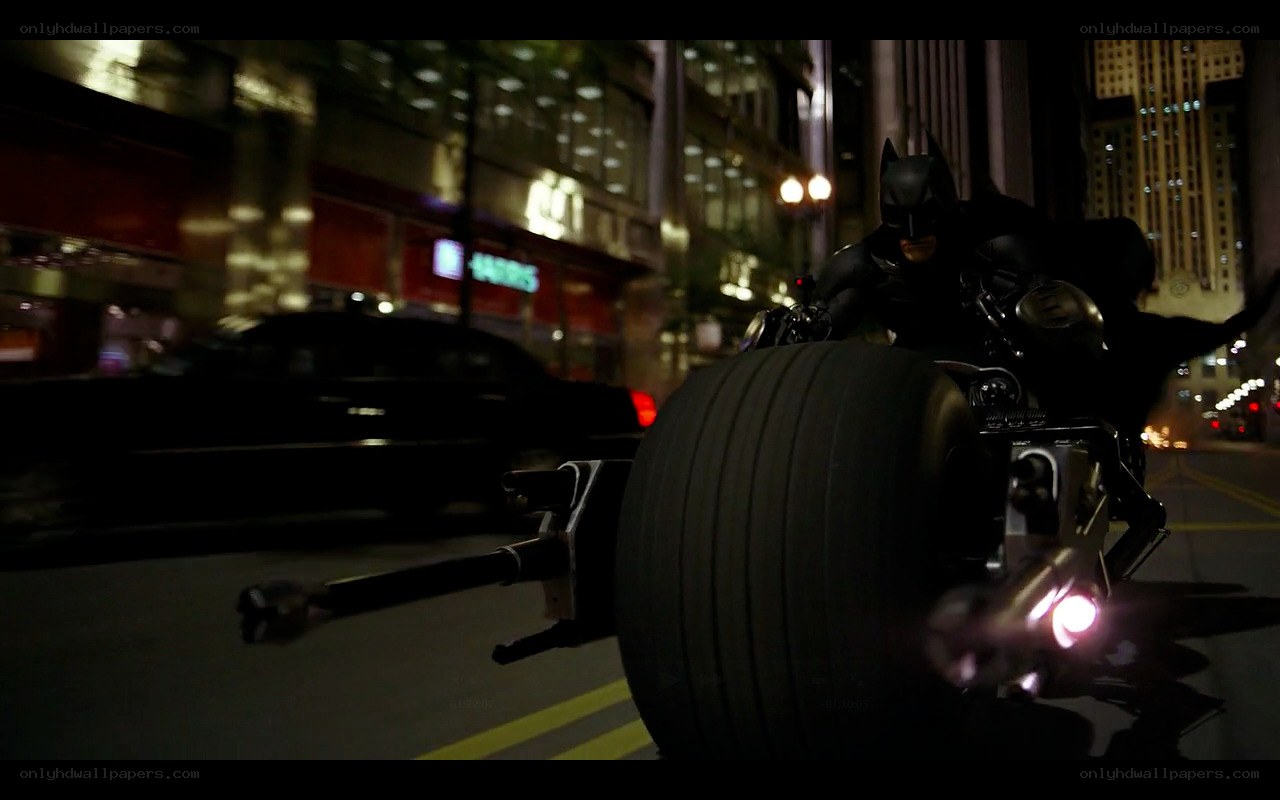 Batman on Batpod at night