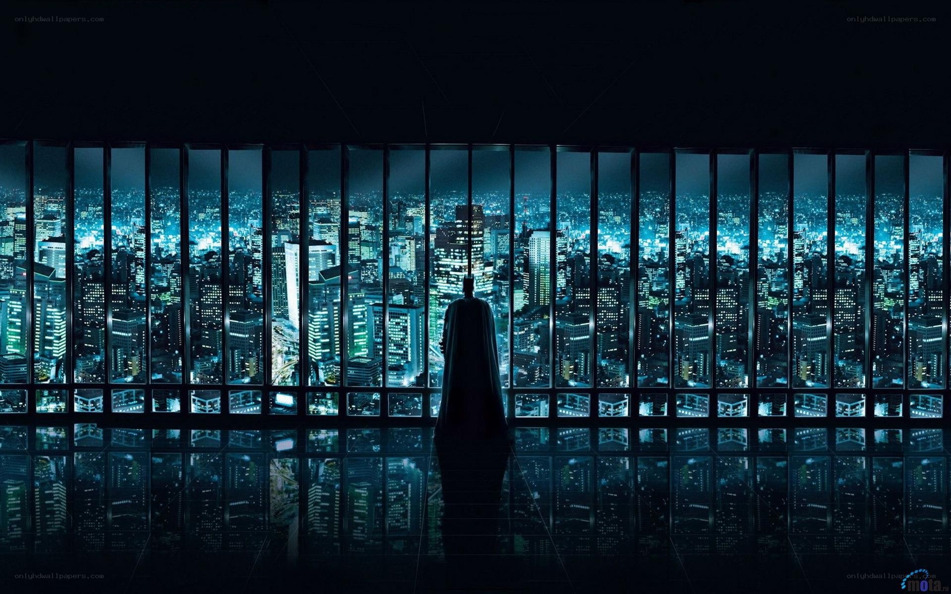 Batman overlooking a city at night