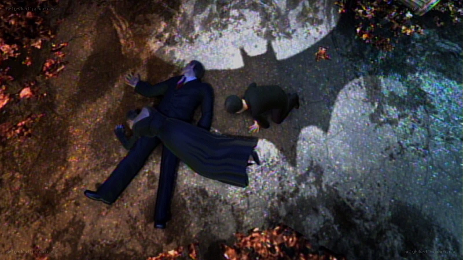 Batman shadow over fallen figures