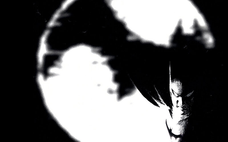 Batman silhouette against moon