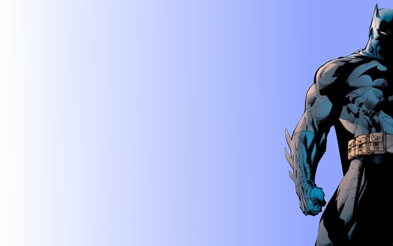Batman standing on blue background