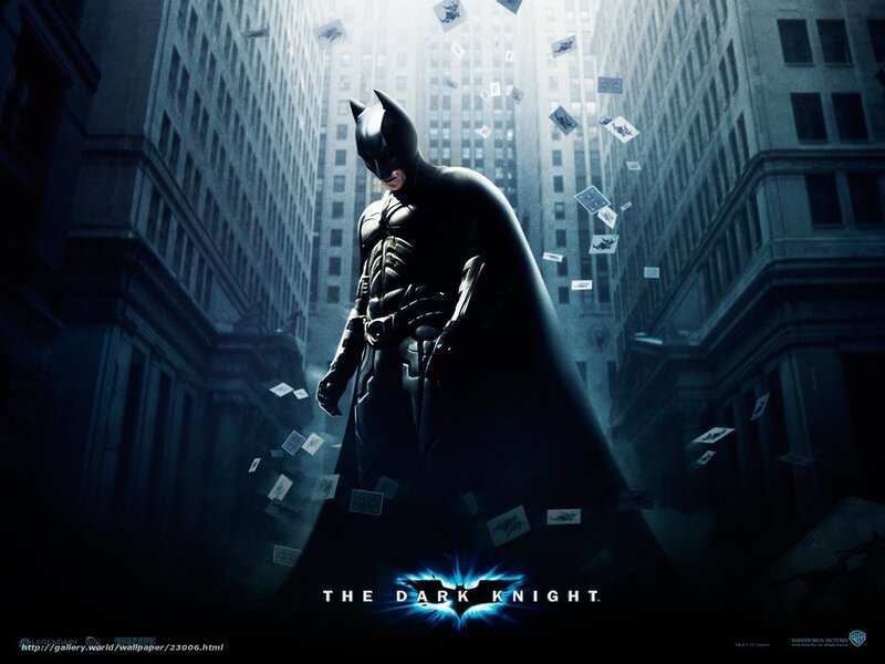 Batman stands in a city alley