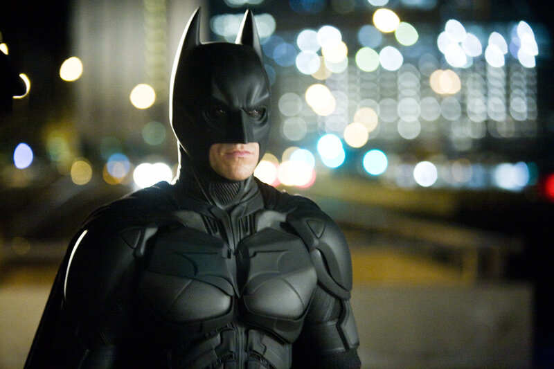 Batman stands in city at night