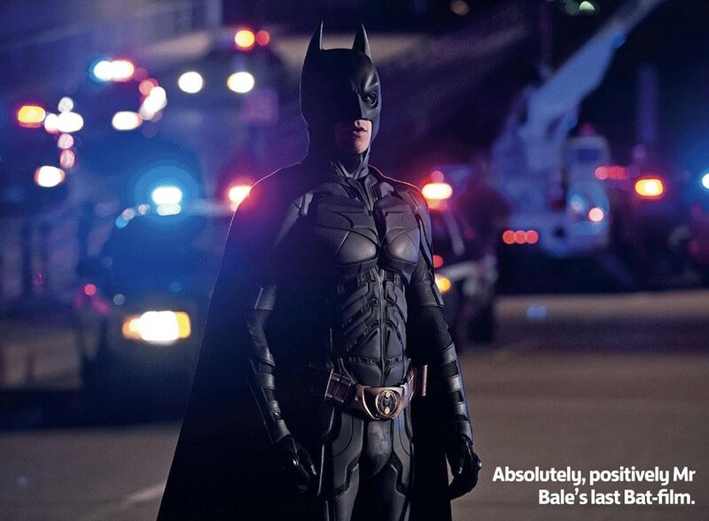 Batman stands in city at night