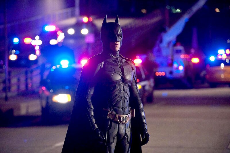 Batman stands in city at night