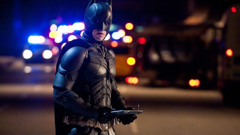 Batman stands in city at night