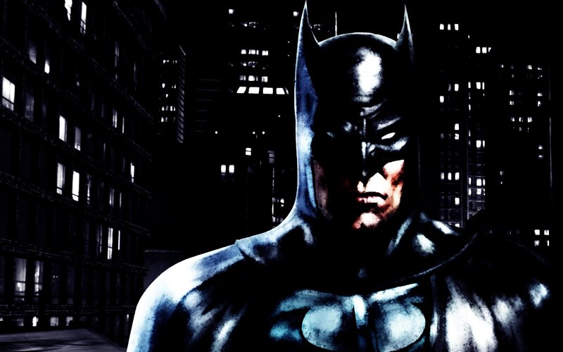 Batman stands in city at night