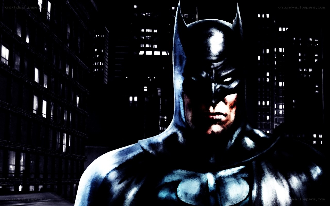 Batman stands in city at night
