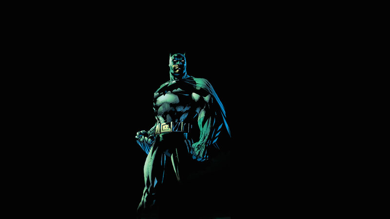 Batman stands in the dark