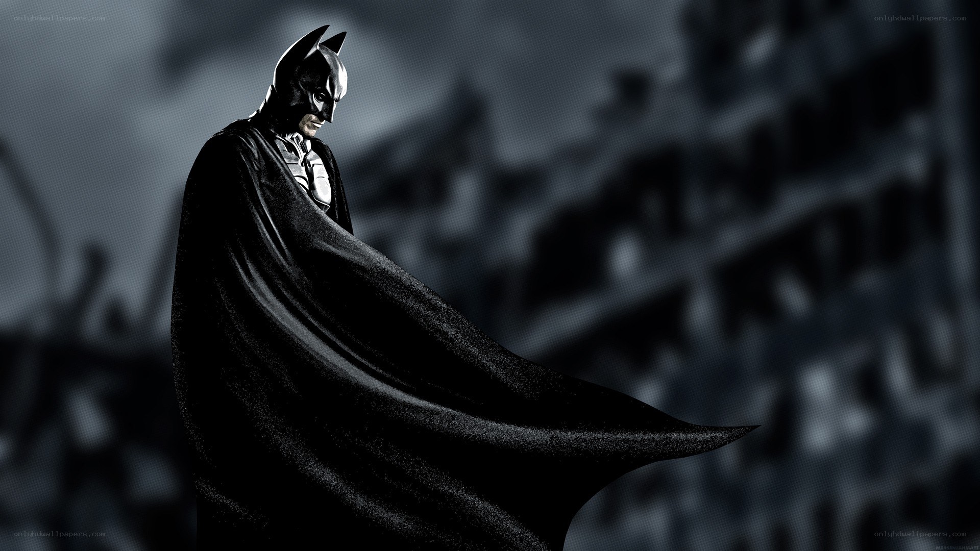 Batman stands in the shadows