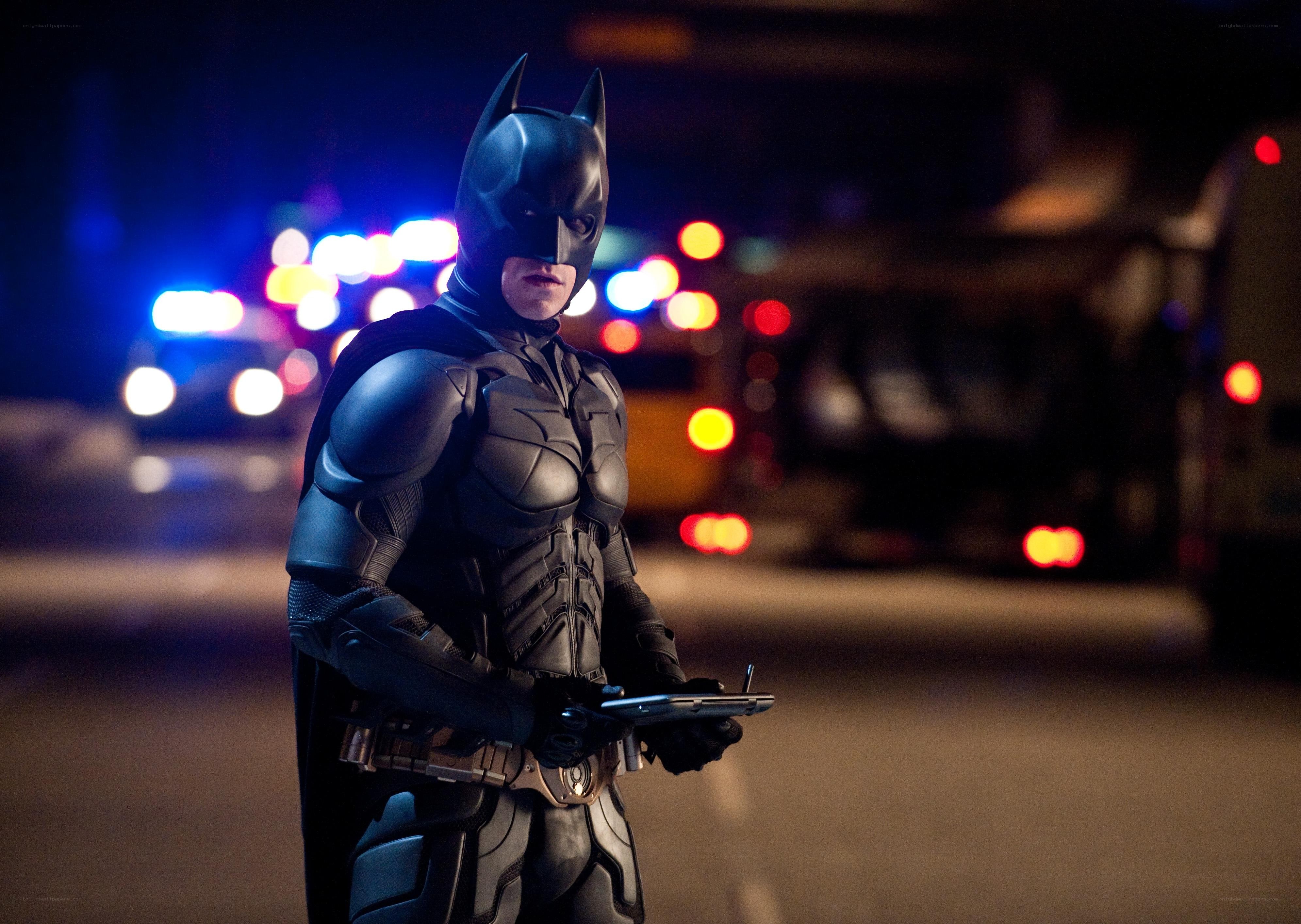Batman stands on a city street